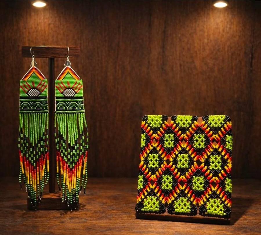 Green and red beaded fringe earrings beside a matching green and black beaded cuff