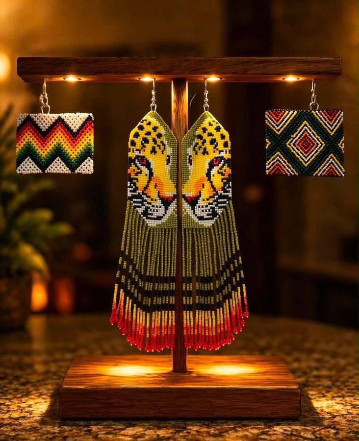 Beaded earrings with leopard faces and long fringes, beside two square beaded earrings