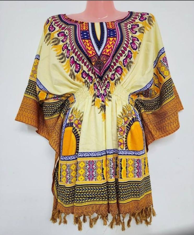 Yellow and gold dashiki kaftan top with tasselled hem displayed on a mannequin