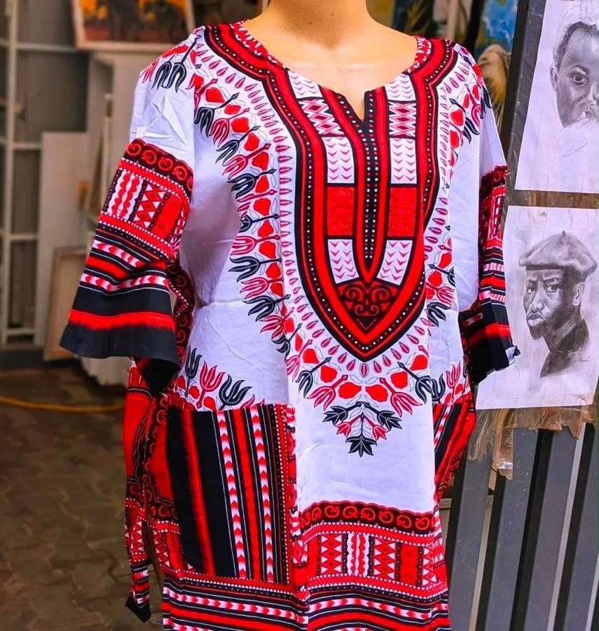 White and red dashiki top with black detailing on a mannequin