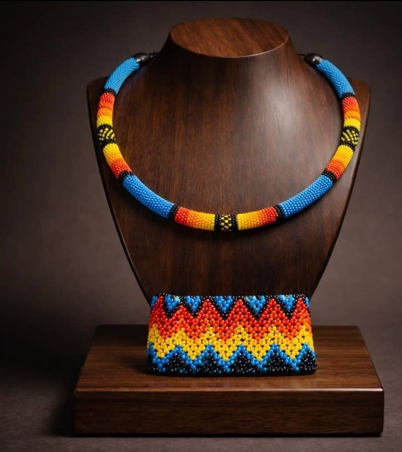 Maasai beaded collar necklace and matching cuff in blue, red, yellow and black on a display stand