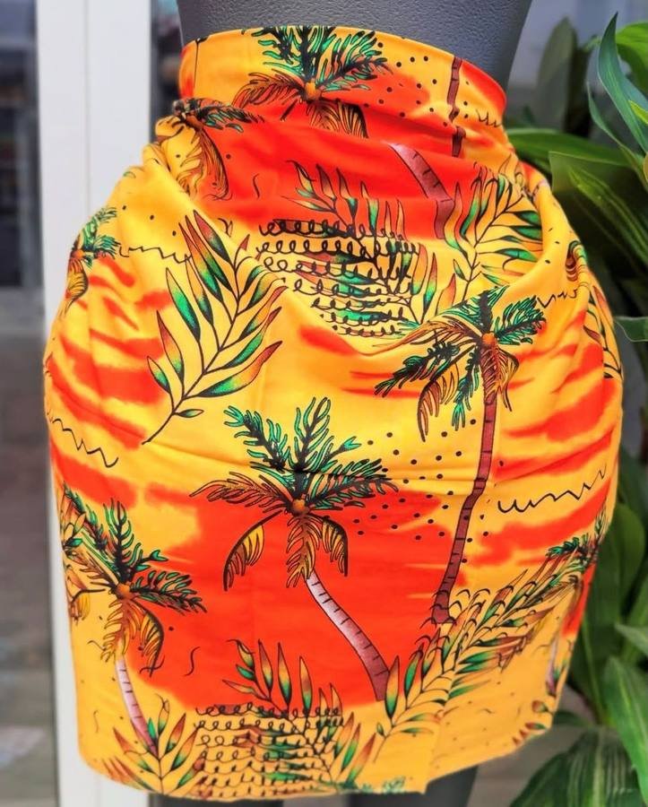 Orange and yellow wrap skirt printed with palm trees and leaves